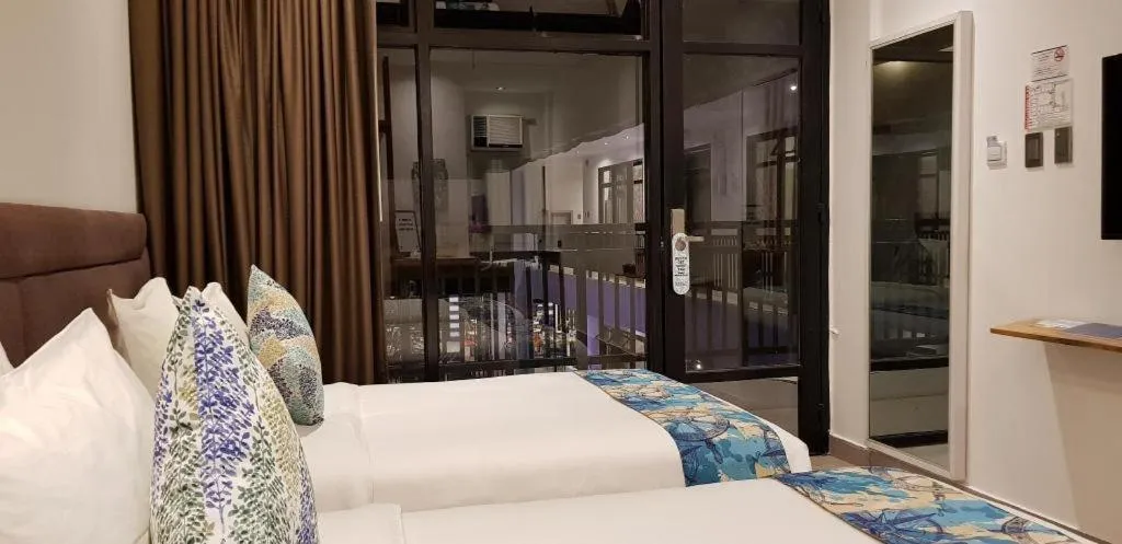 Bed in White Breeze Palawan Boutique Hotel