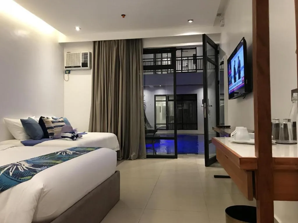 Bed in White Breeze Palawan Boutique Hotel