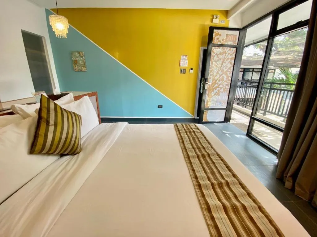 Bed in White Breeze Palawan Boutique Hotel