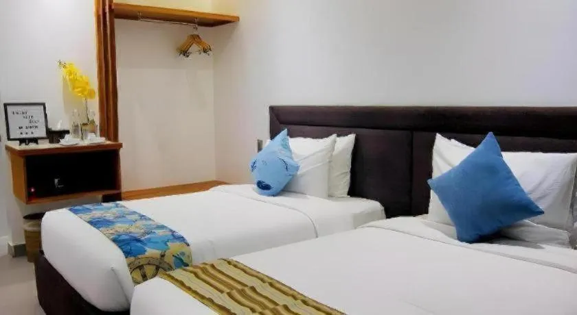 Bed in White Breeze Palawan Boutique Hotel