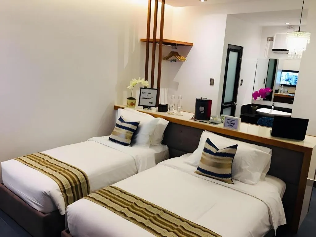 Bed in White Breeze Palawan Boutique Hotel