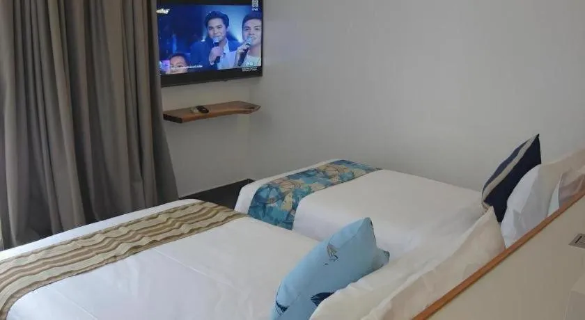 Bed in White Breeze Palawan Boutique Hotel