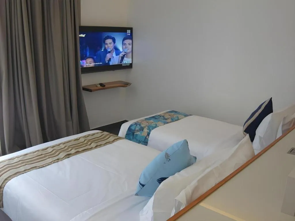 Bed in White Breeze Palawan Boutique Hotel