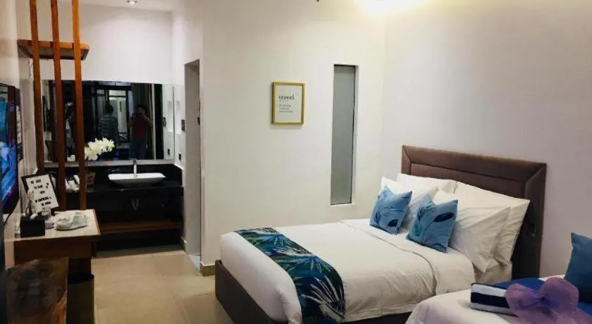 Bed in White Breeze Palawan Boutique Hotel