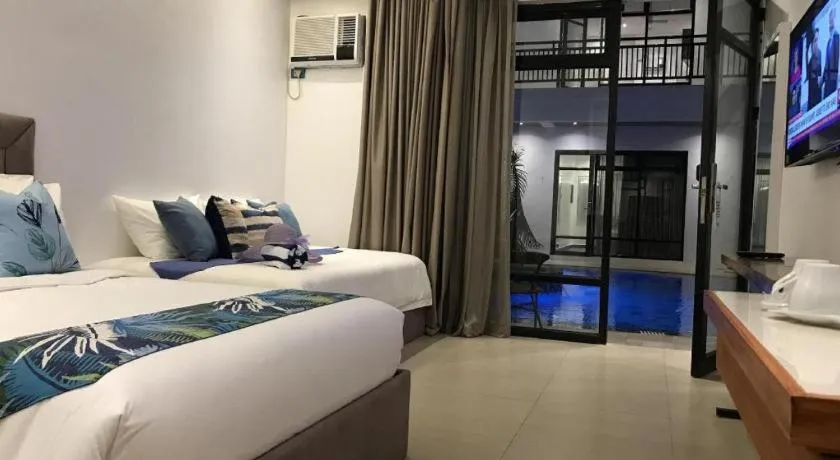 Bed in White Breeze Palawan Boutique Hotel