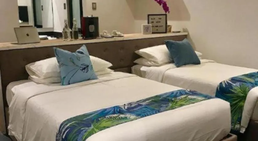 Bed in White Breeze Palawan Boutique Hotel