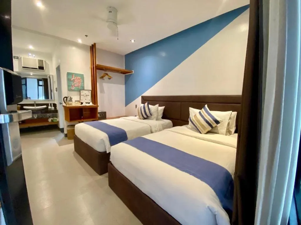 Bed in White Breeze Palawan Boutique Hotel