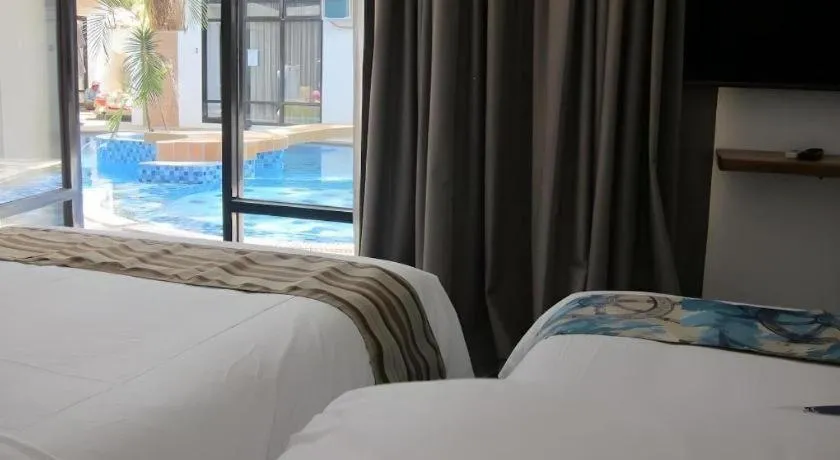 Bed in White Breeze Palawan Boutique Hotel