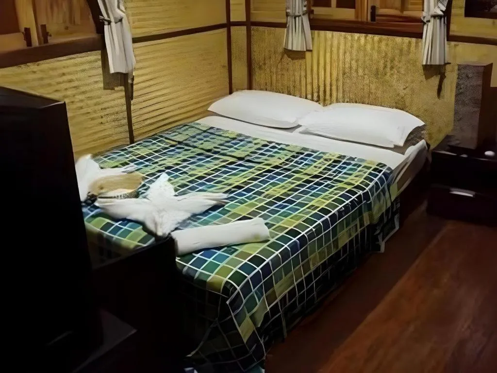 Bed in Green Cottage Beach Resort