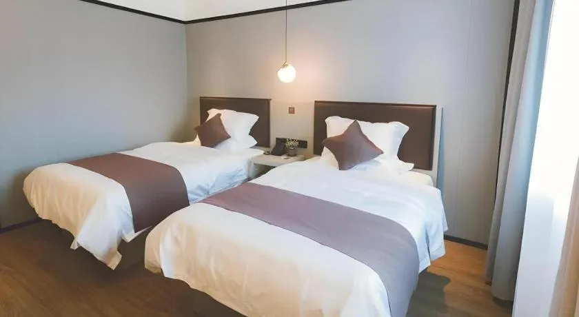 Bed in GYA Shanghai Jiangpu Hotel