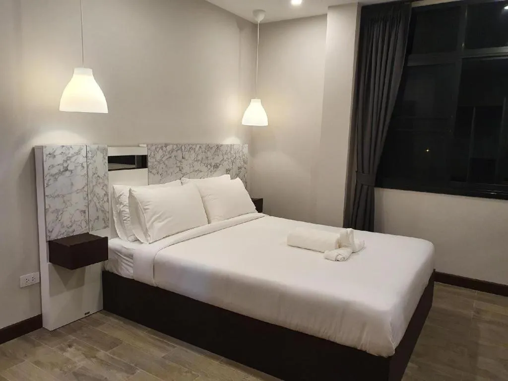 Bed in THE S VILLAS HOTEL