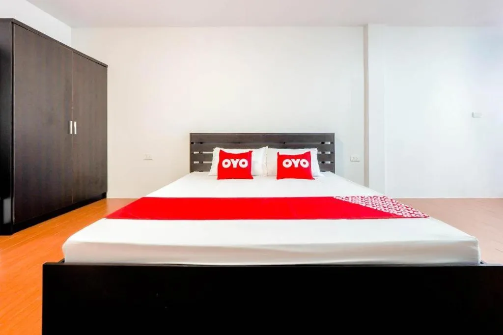 Bed in OYO 935 The Palm Apartment