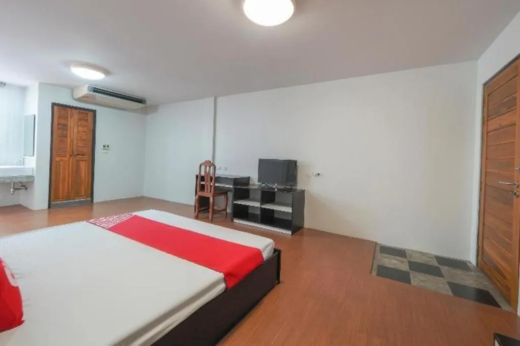 Bed in OYO 935 The Palm Apartment