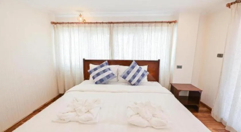 Bed in Chiangkhan Town Hotel