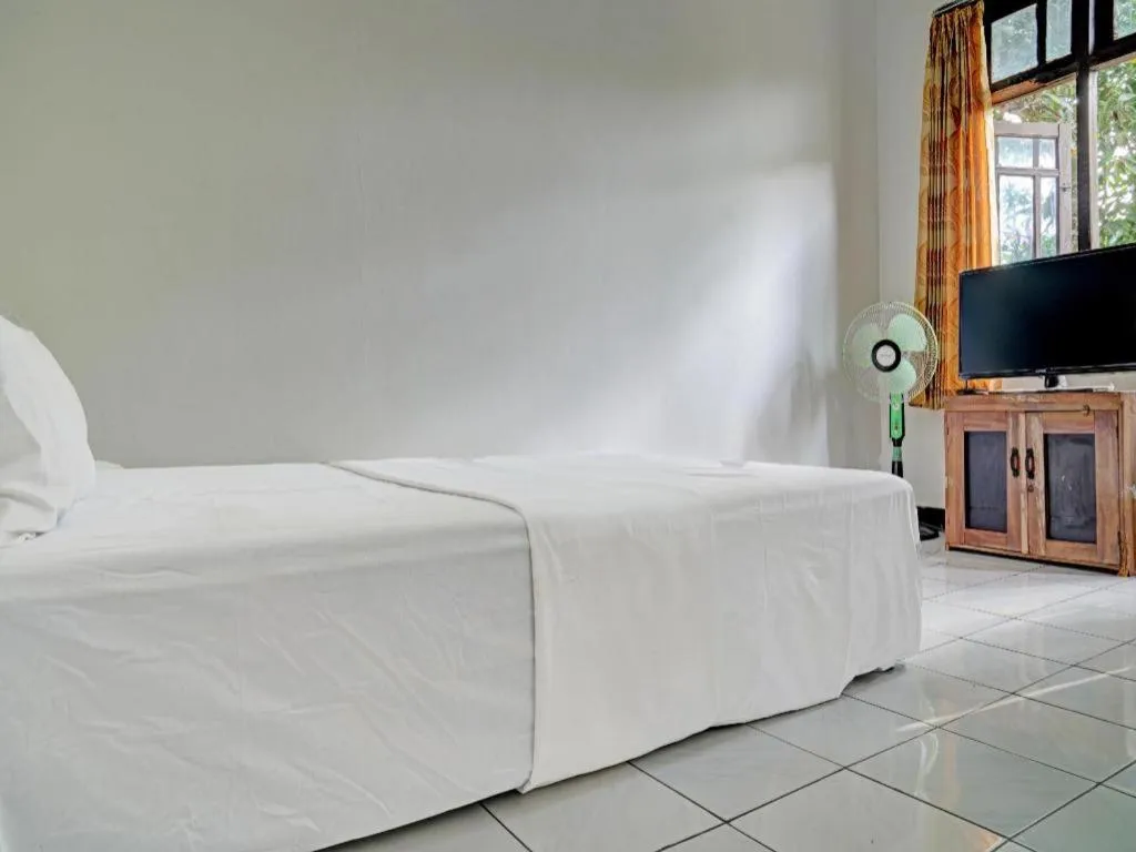 Bed in Hotel O Home Stay Syariah Aom Kusman