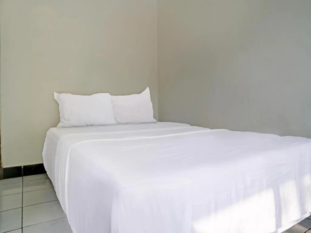 Bed in Hotel O Home Stay Syariah Aom Kusman