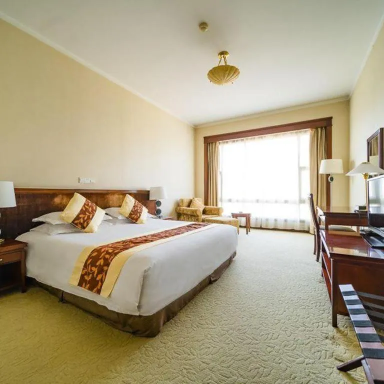 Bed in New Century Hotel Ninghai
