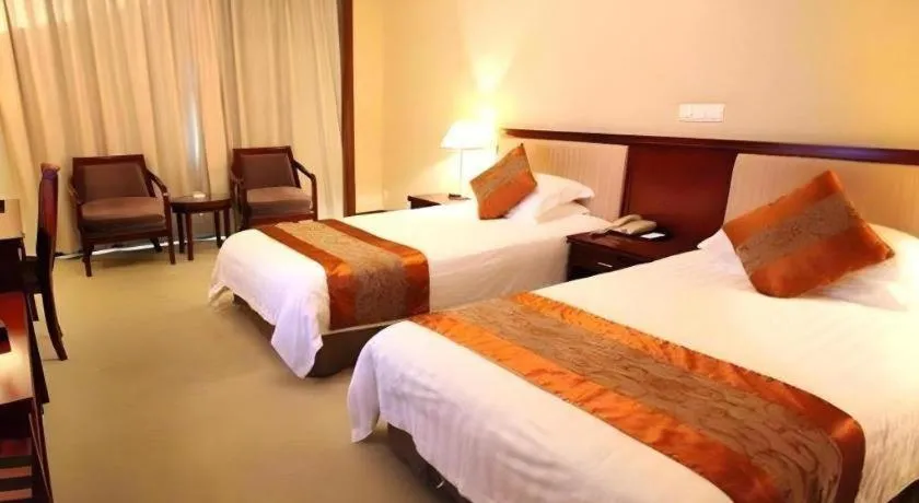 Bed in New Century Hotel Ninghai