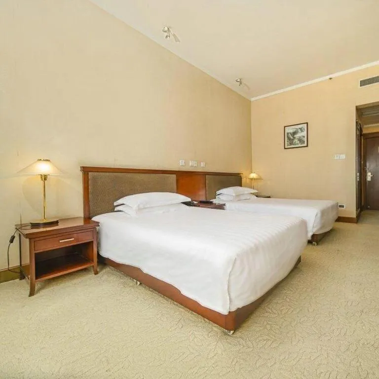 Bed in New Century Hotel Ninghai