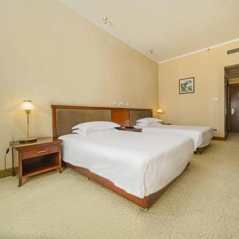 Bed in New Century Hotel Ninghai