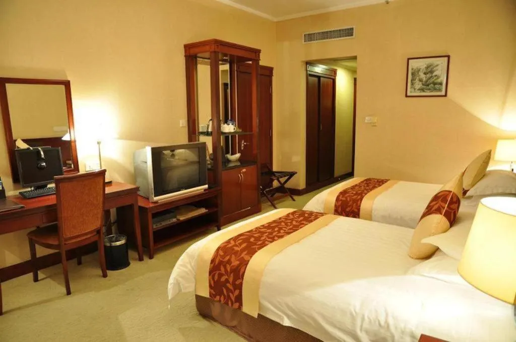 Bed in New Century Hotel Ninghai