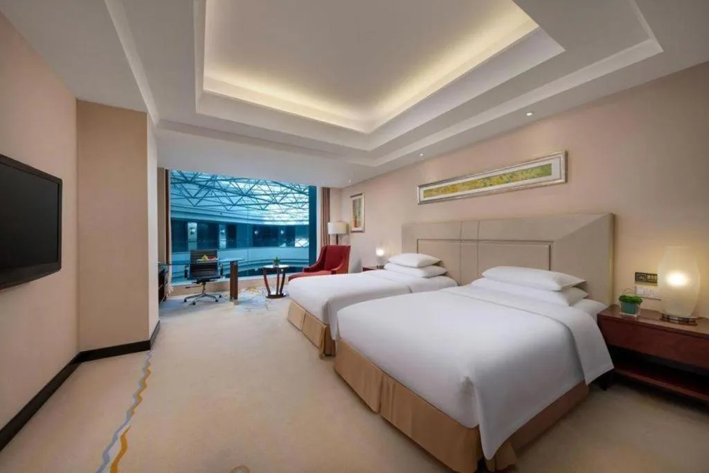 Bed in New Century Grand Changchun Hotel