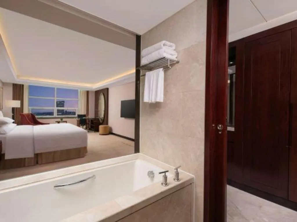 Bed in New Century Grand Changchun Hotel