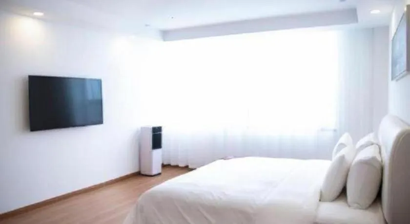 Bed in New Century Grand Changchun Hotel