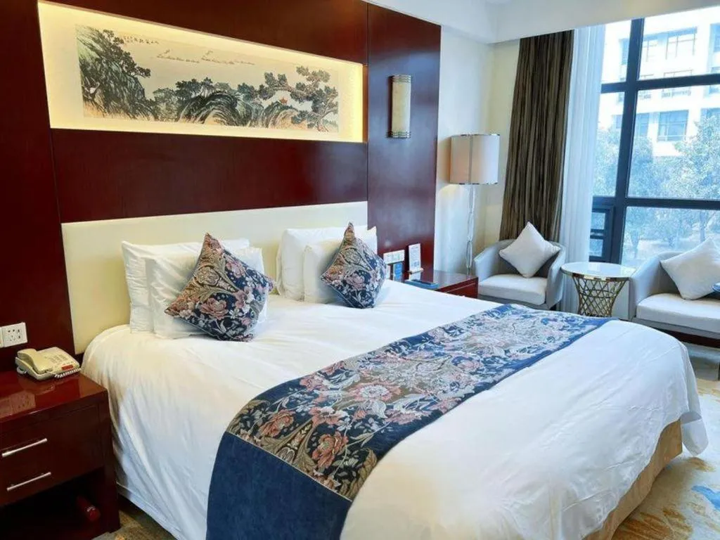 Bed in New Century Hotel Zaozhuang Fengming
