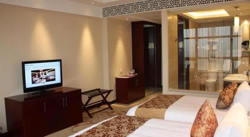 Bed in New Century Hotel Zaozhuang Fengming