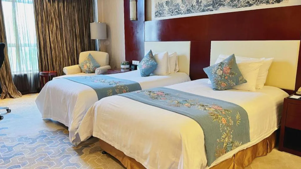 Bed in New Century Hotel Zaozhuang Fengming