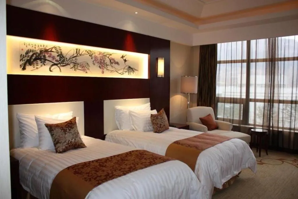 Bed in New Century Hotel Zaozhuang Fengming
