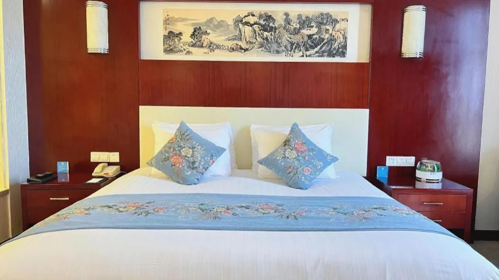 Bed in New Century Hotel Zaozhuang Fengming