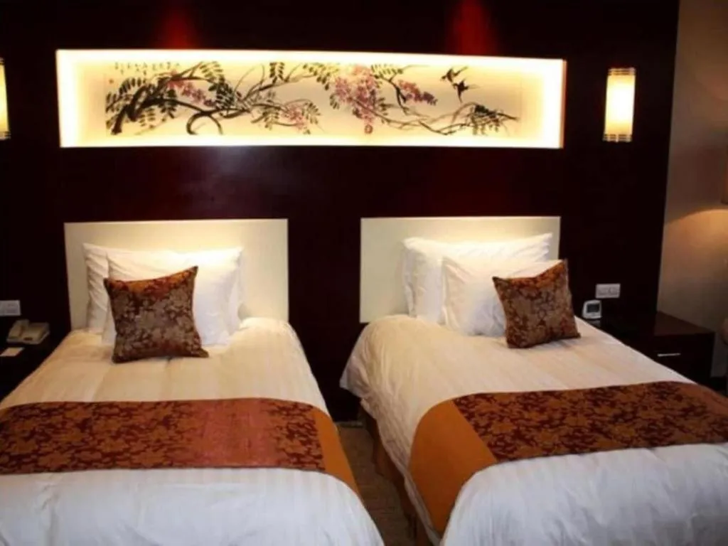 Bed in New Century Hotel Zaozhuang Fengming