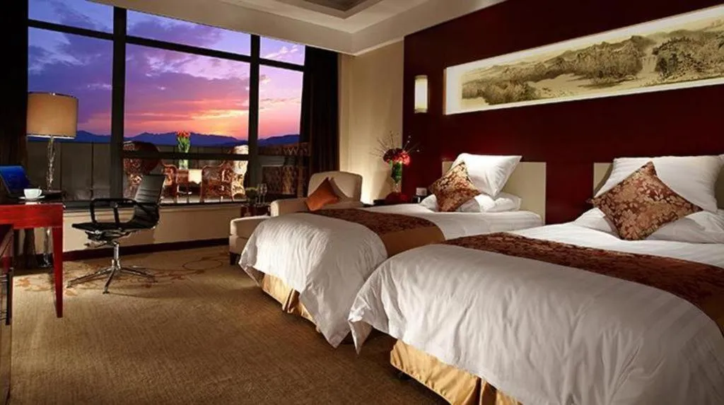 Bed in New Century Hotel Zaozhuang Fengming