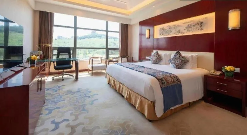 Bed in New Century Hotel Zaozhuang Fengming