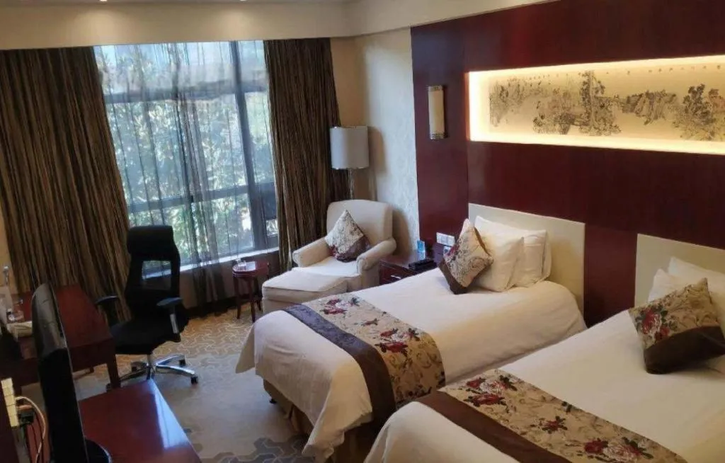 Bed in New Century Hotel Zaozhuang Fengming