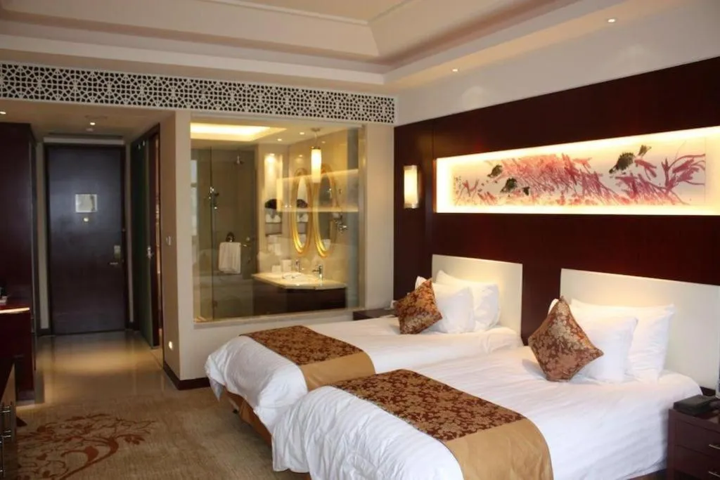 Bed in New Century Hotel Zaozhuang Fengming