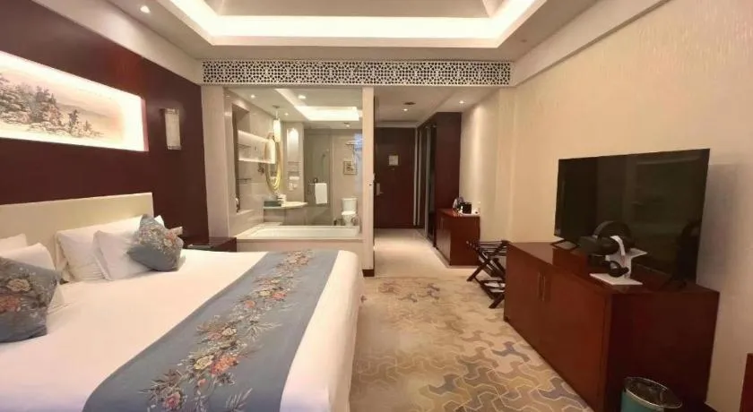Bed in New Century Hotel Zaozhuang Fengming