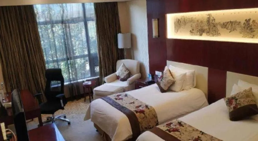 Bed in New Century Hotel Zaozhuang Fengming