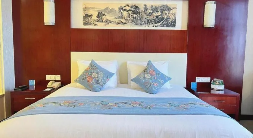Bed in New Century Hotel Zaozhuang Fengming