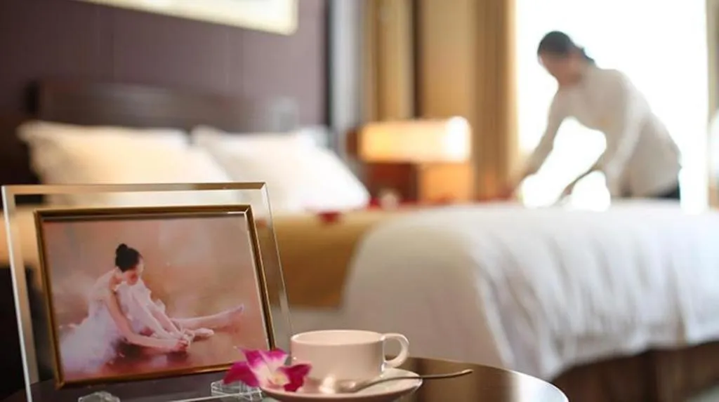 Bed in New Century Hotel Zaozhuang Fengming