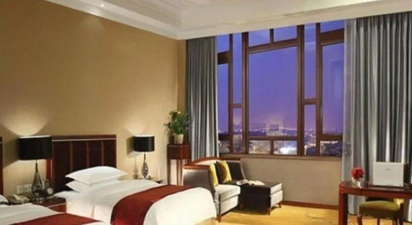 Bed in Xinjin Celebrity City Hotel