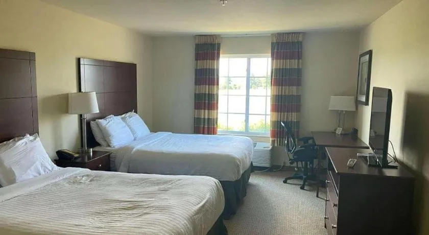 Bed in AmericInn by Wyndham Oshkosh