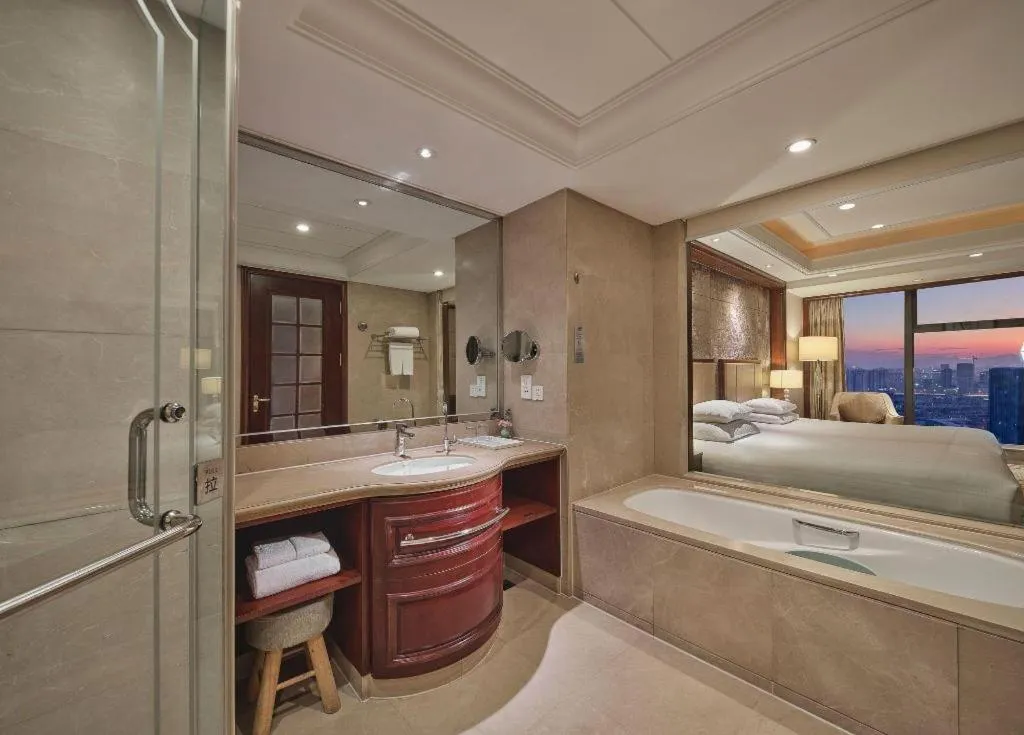Bed in New Century Grand Hotel Zhejiang Sanli