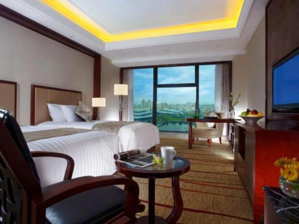Bed in New Century Grand Hotel Zhejiang Sanli