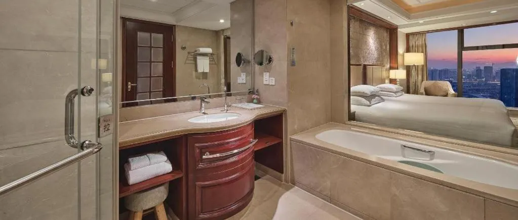 Bed in New Century Grand Hotel Zhejiang Sanli