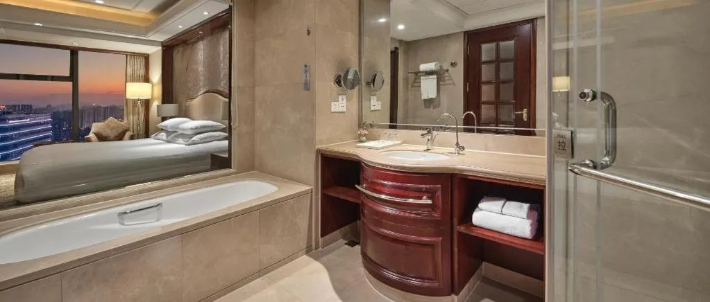 Bed in New Century Grand Hotel Zhejiang Sanli