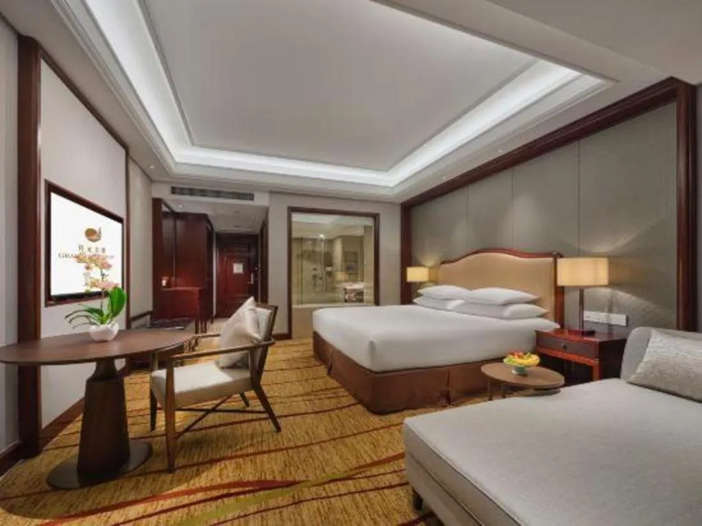 Bed in New Century Grand Hotel Zhejiang Sanli