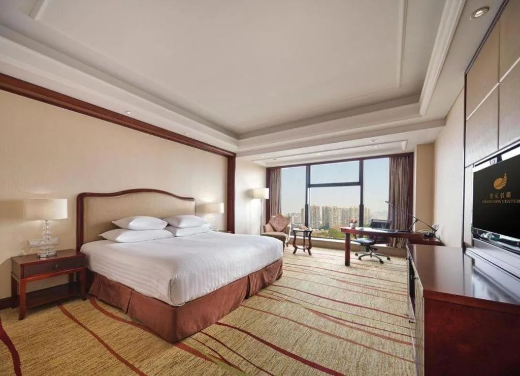 Bed in New Century Grand Hotel Zhejiang Sanli